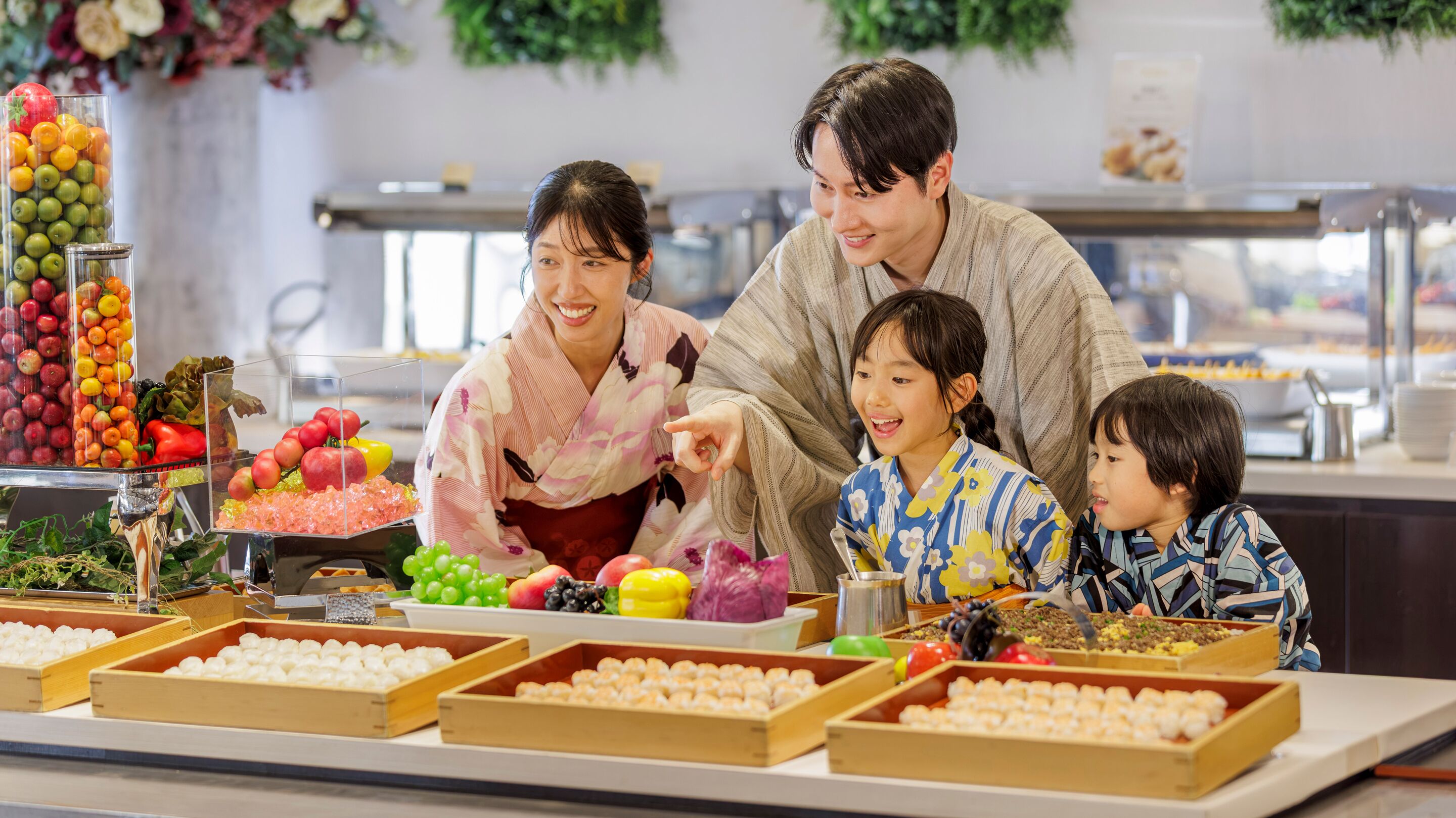 A family at a buffet with various food items and a salad bar.