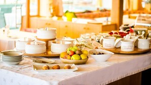 A buffet setup with various food items and serving dishes.