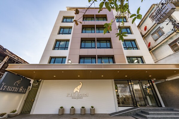 A multi-story hotel with a modern facade, a prominent elephant logo, and a covered entrance.