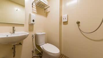 A bathroom with a sink, toilet, and shower.