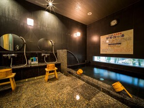A modern bathroom with a granite floor, two sinks with mirrors, a wooden stool, a bathtub, and a clock on the wall. - Super Hotel Suzuka (Suzuka)