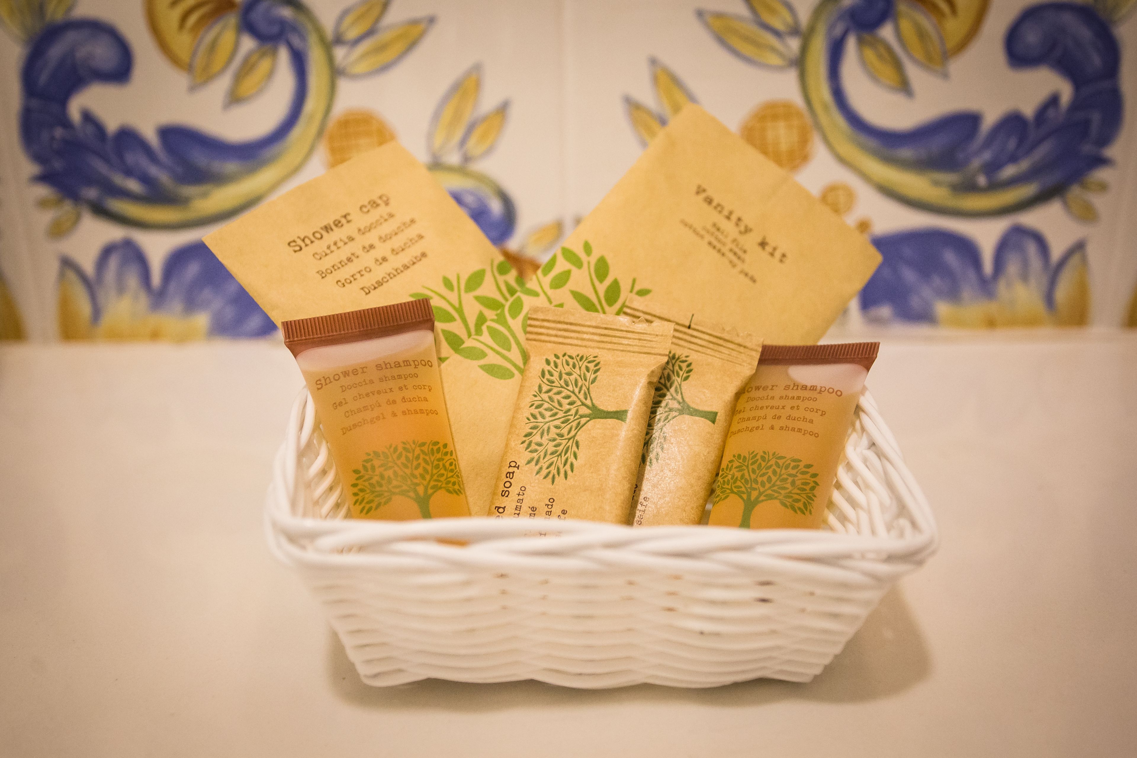 A basket containing several packages of shower shampoo.