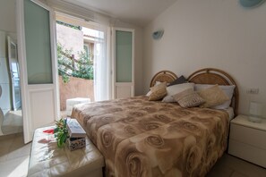 Apartment, 2 Bedrooms | 1 bedroom, cots/infant beds, bed sheets - Green 1 (Trinità d'Agultu e Vignola)