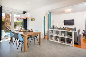 Enjoy meals in the dining area with a wooden table and comfortable seating.