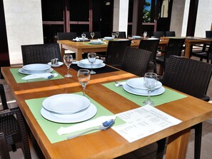 A restaurant with tables set for dining, including plates, glasses, and cutlery. - Hotel Ana Murter (Murter-Kornati)