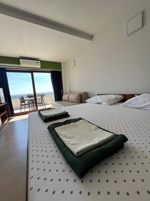 A hotel room with a large bed, a desk, and a view of the outdoors. - Hotel Ana Murter (Murter-Kornati)