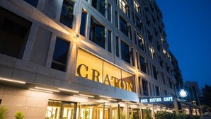 A modern building with a prominent "CRATON" sign and an "OMIX BISTRO CAFE" sign. - The Craton Hotel (Istanbul)