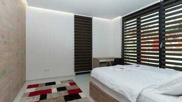 Exclusive Penthouse, Garden View | In-room safe, desk, laptop workspace, blackout drapes