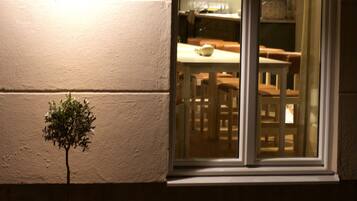 A potted plant outside a sliding glass door leading to a kitchen area.