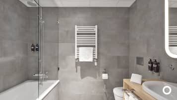 A modern bathroom with a glass shower enclosure, a white bathtub, a toilet, and a vanity with a sink and towel rack.