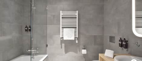 A modern bathroom with a glass shower enclosure, a white bathtub, a toilet, and a vanity with a sink and towel rack.