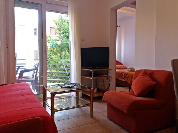 Economy Apartment, City View | Living area | Flat-screen TV