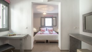 A narrow room with a bed, a desk, and a bench. - Ithaka Deluxe Home (Zakynthos)