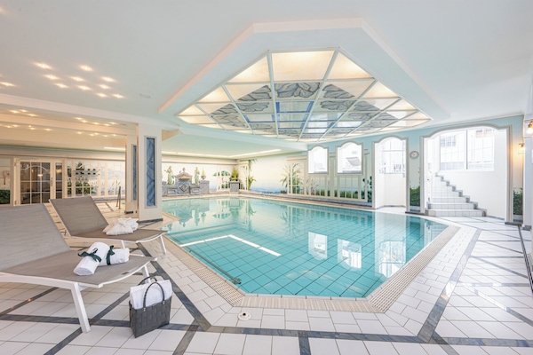 Indoor pool, open 7:00 AM to 10:00 PM, pool loungers