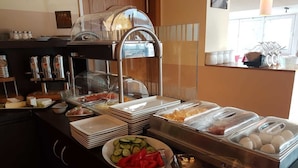 A buffet setup with various food items including cheese, meats, and vegetables. - Hotel & Restaurant La Baia (Cochem)