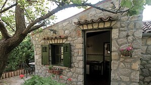 A stone building with a kitchen visible inside.