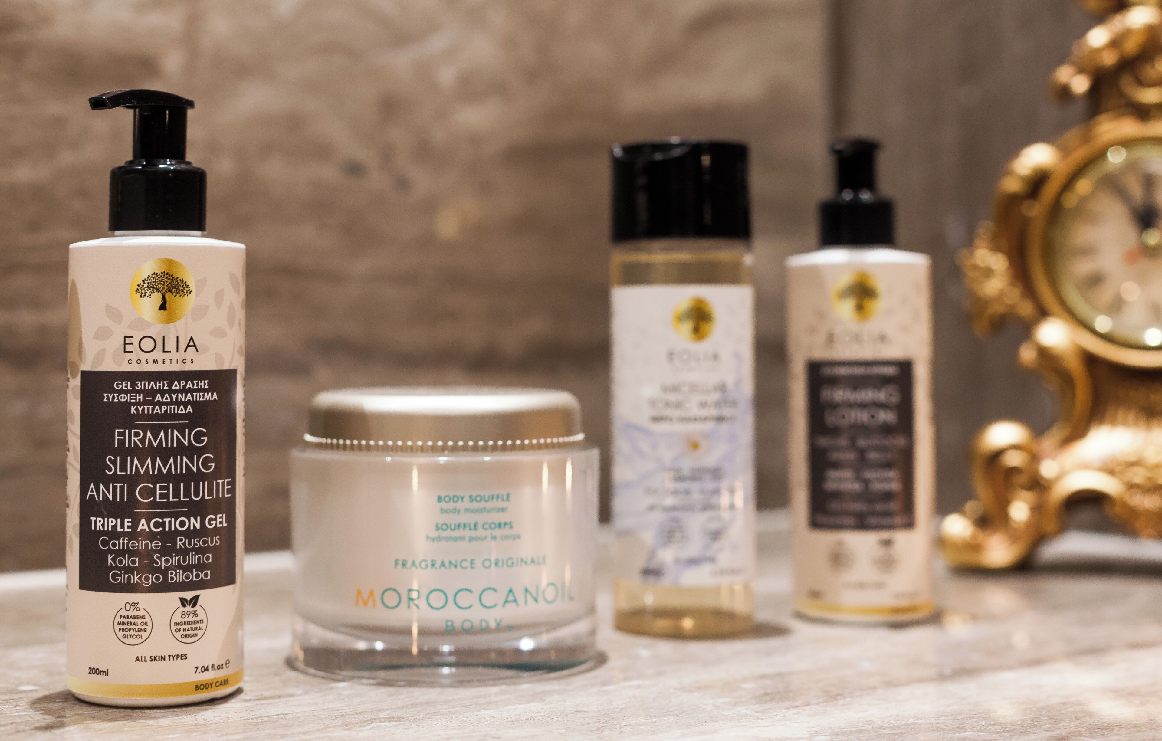 A selection of skincare products including a body mousse, a triple action gel, and a body care jar.