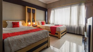 A hotel room with two beds, a TV, and a large window with curtains. - RedDoorz Syariah @ Cipanas (Cipanas)
