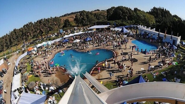 A water park with multiple pools, a large slide, and a crowd of people. - Mantagua Village (Quintero)