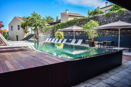 Outdoor pool, pool loungers. Volcanic Charming House