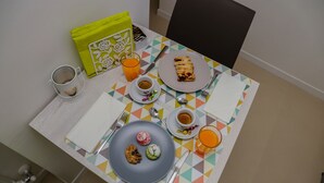 A breakfast table with a plate of pastries, a cup of coffee, and a glass of orange juice. - La Civita B&B (Gravina in Puglia)