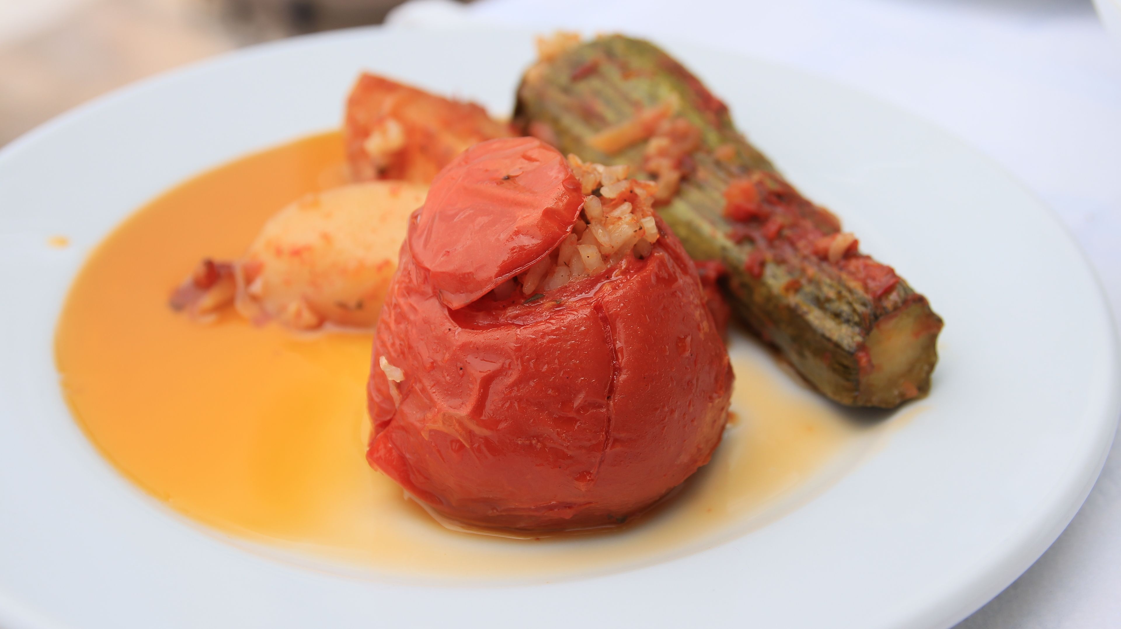 A plate with stuffed vegetables and a sauce.