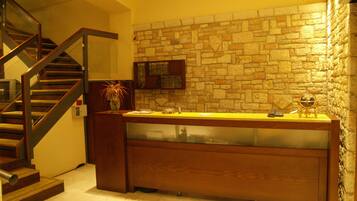 A modern kitchen with a stone wall backsplash, a wooden counter, and a built-in stove.