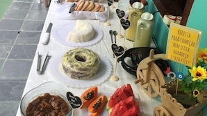 A breakfast buffet with various dishes and utensils laid out on a table.
