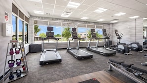 A gym with treadmills, a weight bench, and kettlebells. - Fairfield Inn & Suites by Marriott Dallas Plano/Frisco (Plano)