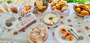 A table with various food items including bread, pastries, and fruits. - Pousada Sobre As Ondas De Picinguaba (Ubatuba)