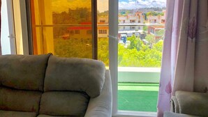 A balcony with a view of buildings and greenery. - H20 Apartment (Mombasa)