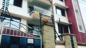 A multi-story building with balconies, a sign indicating a sale, and a visitor sign on the right. - H20 Apartment (Mombasa)