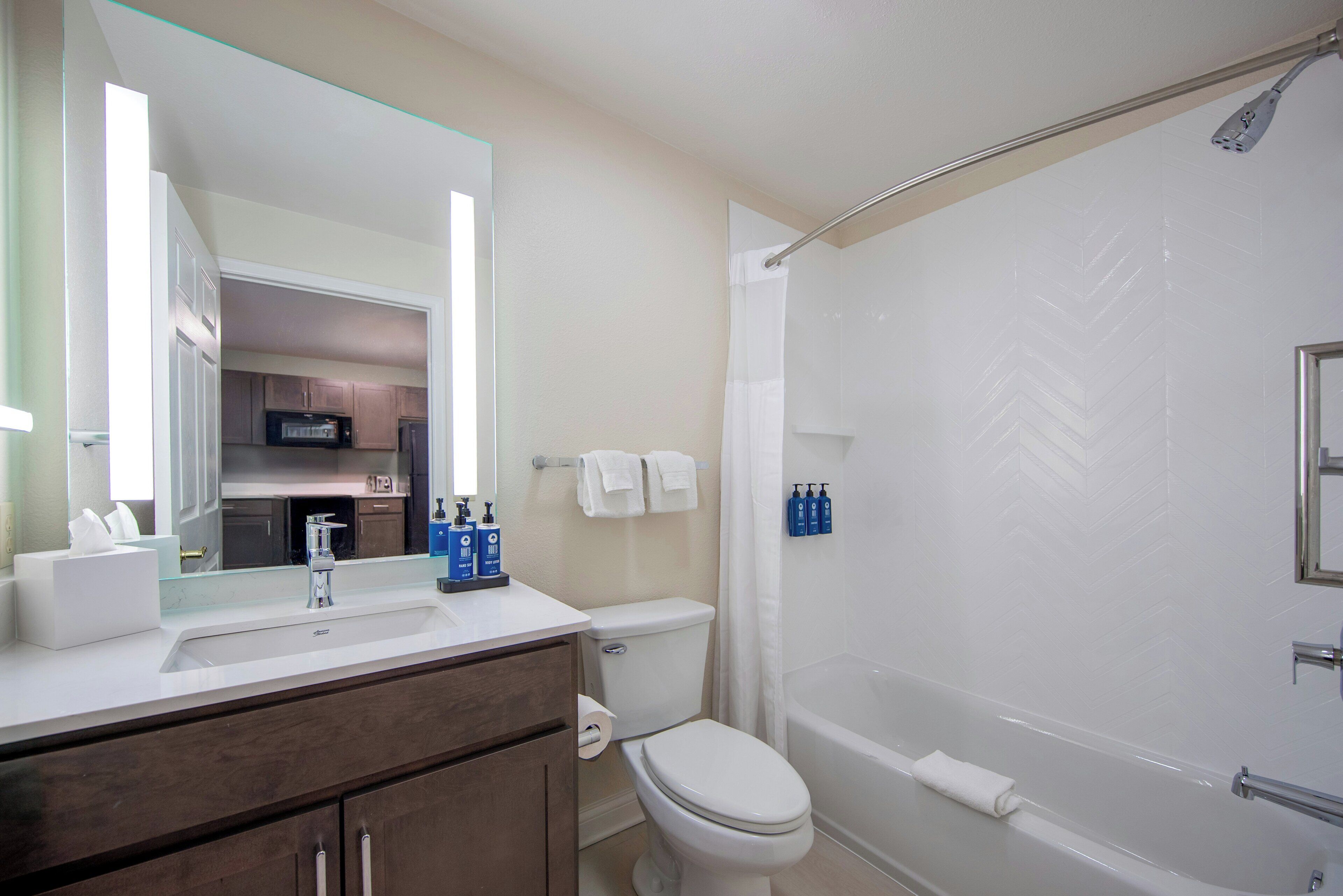 A bathroom with a sink, toilet, and bathtub.