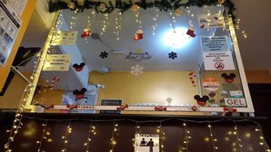 A hotel reception area with a Christmas theme, including decorations and signs.