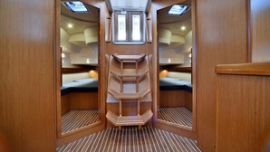 A compact interior with a central shelf, two beds, and skylights.