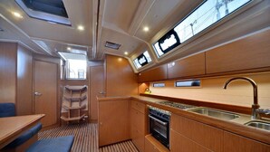 A compact kitchen with wooden cabinets, a stove, and a sink.
