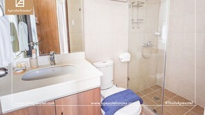 A modern bathroom with a sink, toilet, and shower.