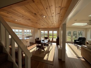 A spacious kitchen with a large island, wooden ceiling, and large windows offering views of the outdoors. - WELLS BEACH FRONT - Direct Beach Access, ocean views, only 1 wk left July 18-25 (Wells)