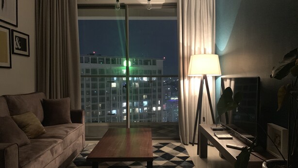 Ein modernes Wohnzimmer mit einer Couch, einem Couchtisch und einer Lampe.