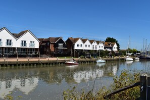 Houses line a serene waterway, offering scenic views and moored boats.