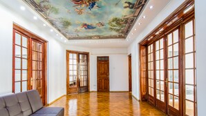 A spacious hallway with wooden flooring and large windows, leading to a door with a wooden frame. - Unique apartment situated in the real heart of Bucharest  (Sector 1)