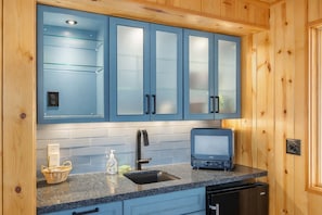A kitchen with blue cabinets, a microwave, a sink, and a dishwasher. - Lakefront | Dock | Hot Tub | Deck | Dogs | Views (Leavenworth)