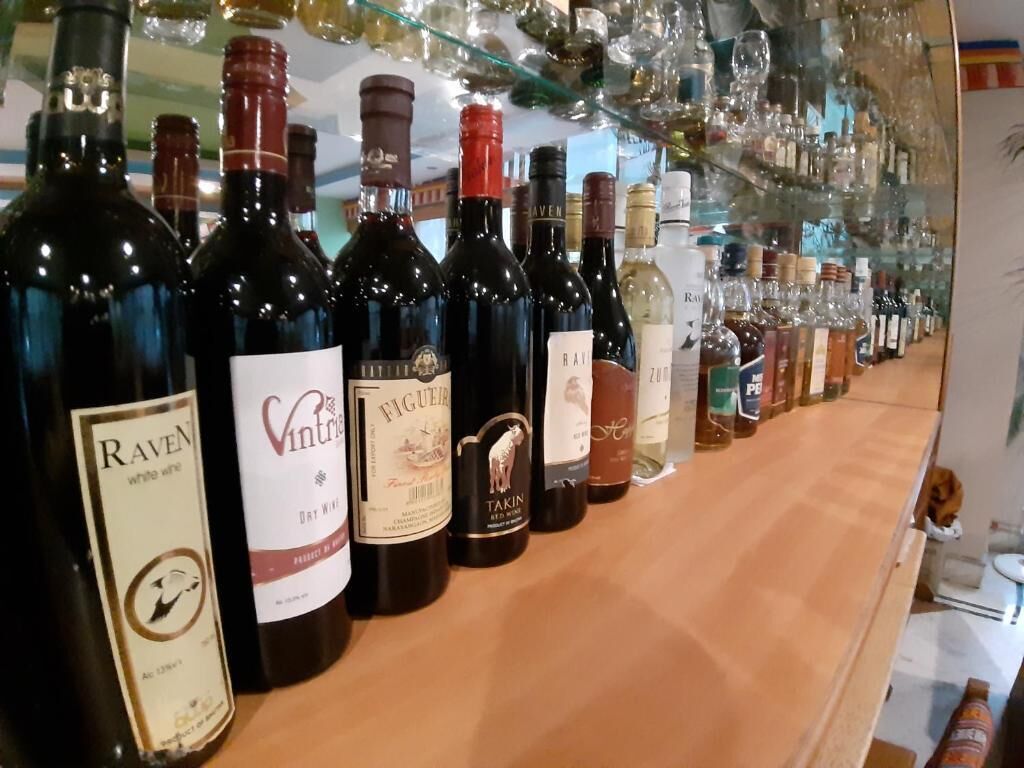 A selection of wine bottles on a wooden counter.
