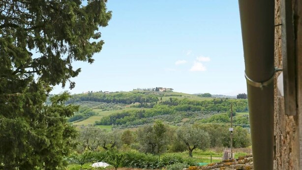 A view of a rural landscape with a hill and a building in the distance. - Chiantihouse near Florence (Montespertoli)