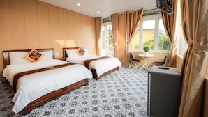A hotel room with two beds, a desk, a chair, and a TV. - Sen Da Villa - Succulent Villa (Xuan Huong - Da Lat)