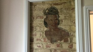 A framed portrait of a person on a brick wall. - 3 Bedroom historic house in Norfolk (Thetford)