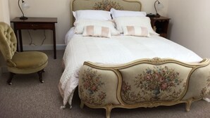 A bedroom with a bed, a chair, a nightstand, and a desk. - 3 Bedroom historic house in Norfolk (Thetford)