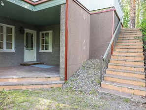 A house with a porch, a set of outdoor stairs, and a door with shutters. - Vadelma by Interhome (Sotkamo)
