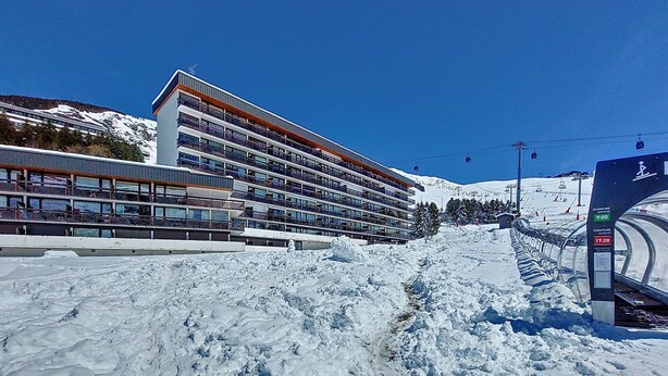 A modern hotel with multiple floors and balconies, situated near a ski slope with a snow-covered landscape. - Aravis 314 by Interhome (Les Menuires)