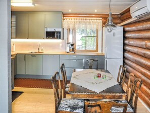 A compact kitchen with a microwave, sink, and refrigerator.